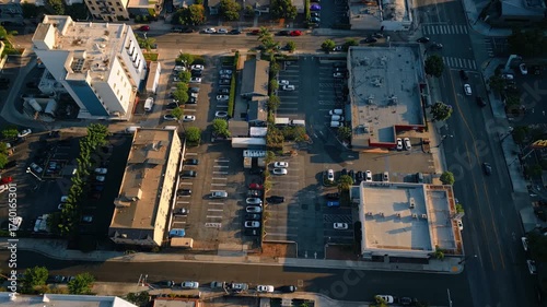Parking lots near the high-rise buildings. Drone footage over the neighborhood of Los Angeles, California, USA at sunset.