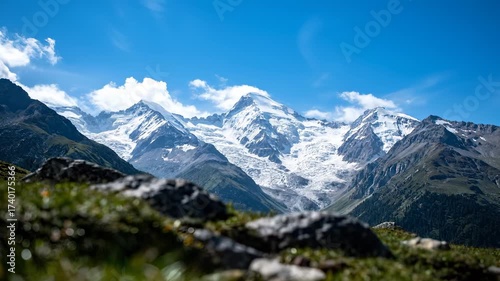 Wallpaper Mural Snowy mountains rise under the blue sky, where mountains dominate the vast landscape. Green slopes contrast with the white mountains in this scenic view. Torontodigital.ca