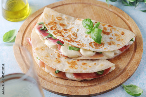 Traditional Italian dish Piadina romagnola - flat bread with mozarella and proscuitto