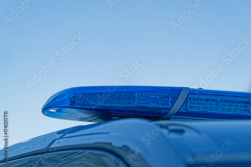 Blue police lightbar beacon mounted on the patrol vehicle roof