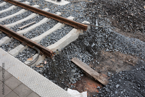 Disruption on the railroad and railway track. Part of rail is missing - obstacle and barrier on the line. Transport incident and damage or infrastructure construction. Shallow focus