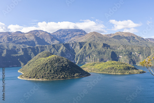 Cotacachi, Ecuador – August 5, 2025: Cuicocha Lagoon in the Ecuadorian Andes, surrounded by vegetation. In the background, the majestic Cotacachi Volcano with its summit hidden among the clouds.