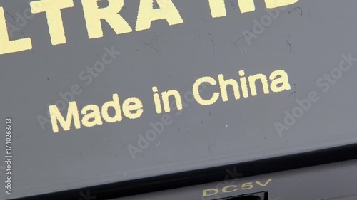 Made in China text PRC product origin marking on generic electronic device hardware with Chinese components semiconductors, electronics manufacturing import export label macro closeup detail, nobody