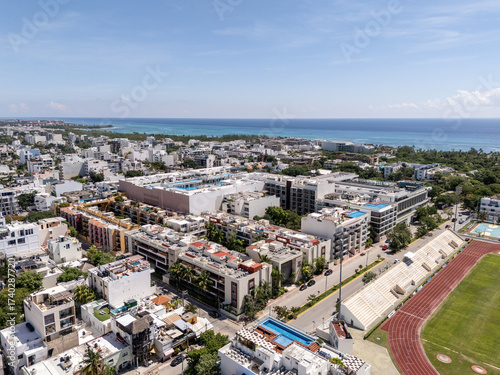 Drone landscape view of downtown area in Playa del carmen with blue Caribbean Sea in the background on a sunny morning 