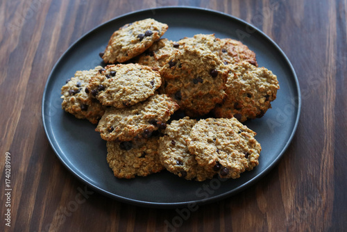 Homemade oatmeal banana cookies with chocolate chips on gray plate