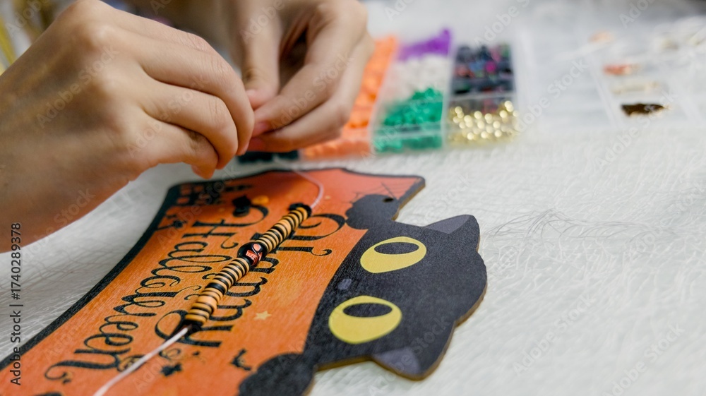 Obraz premium The child is preparing for Halloween, creating holiday decorations with their own hands.