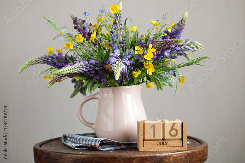 Wildflower bouquet with lupine and buttercup marking july 16