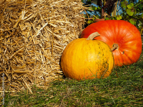 Hay Bale on the Left and Two Pumpkins on the Right — Dark Orange and Yellow-Orange Autumn Decoration