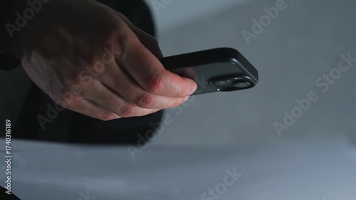 Office work with paper documents.
A man scans information from a form using a mobile device.
Modern technologies for transmitting information.
Paper, office, information, gadget, mobile phone