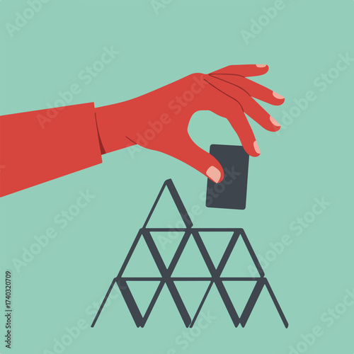 Hand placing final card onto unstable structure