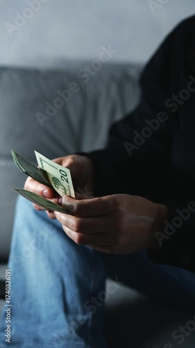 A man counts his money and plans his budget and expenses.
Monetary profit from business and investments.
An investor with cash in hand.
American dollars in the hands of a businessman.