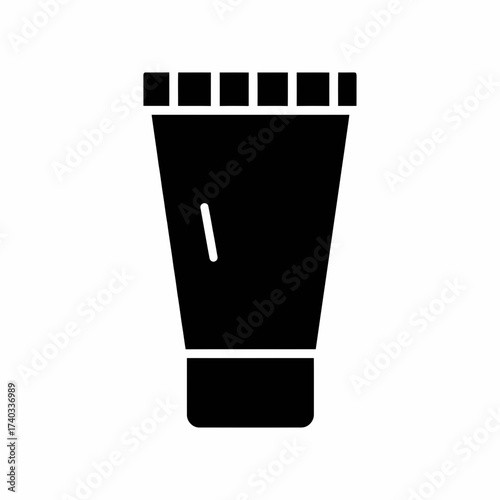 A simple black silhouette of a squeeze tube with a ribbed cap.