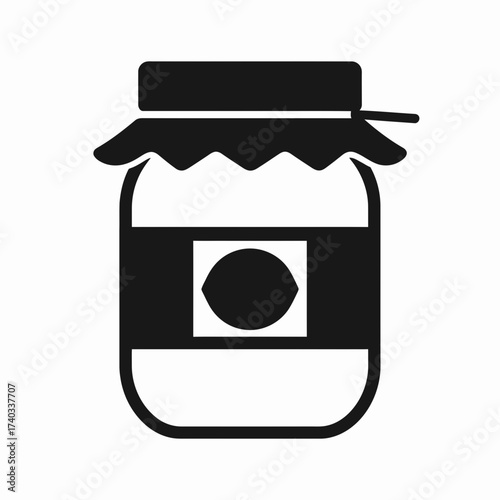 A simple black and white icon of a jar of homemade preserves, featuring a cloth-covered lid and a label with a citrus fruit design.
