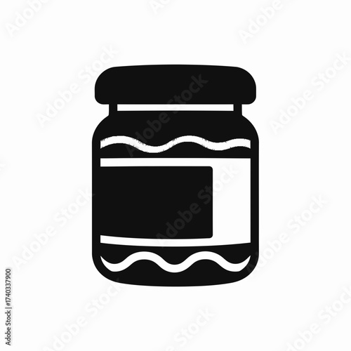 A simple black silhouette icon of a glass jar filled with jam or preserves, featuring a blank label on a white background.