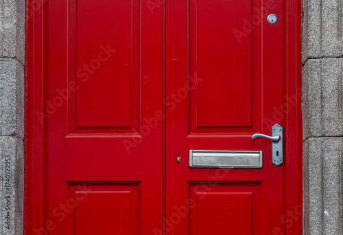 Colorful red door and the doorstep, the symbol of the city,  in the center of Dublin in Respublic Ireland