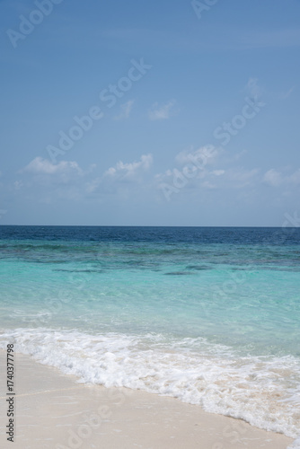 Clear waves on tropical sandy beach