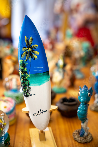 Colorful surfboard souvenir with palm tree design from Maldives