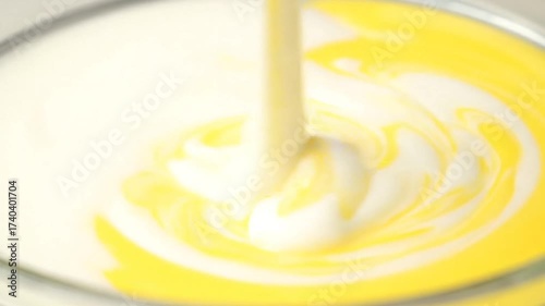 Wallpaper Mural Bright Yellow Liquid Pours into Smooth White Mixture Creating Abstract Swirls Close Up Still Life Shot with Soft Focus and Clean Backdrop Torontodigital.ca
