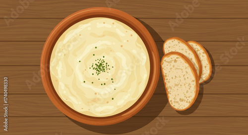 Creamy Açorda soup in a bowl with bread on wooden table, top view