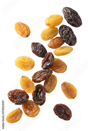 Assortment of Golden and Dark Raisins Scattered on Black Background dried fruit golden raisins