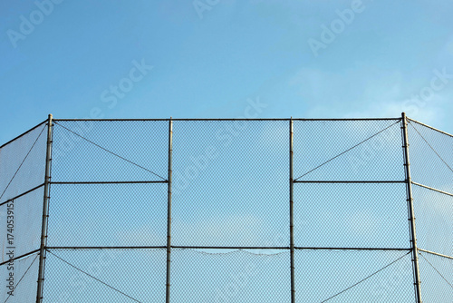 High fence around a baseball sports field