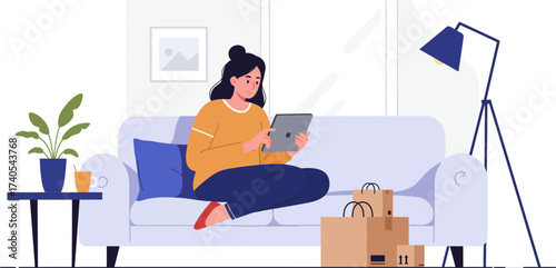 Young woman relaxing on sofa using tablet with shopping bags and cozy home setting reflecting