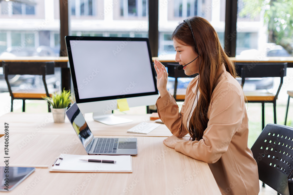 Obraz premium Talking, happy asian woman and customer service in call center with headset, communication and online consulting. Smile, friendly consultant and sales office CRM contact support, advice or business 
