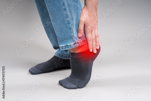 Achilles tendon injury, joint inflammation, foot pain, man suffering from feet ache, podiatry concept