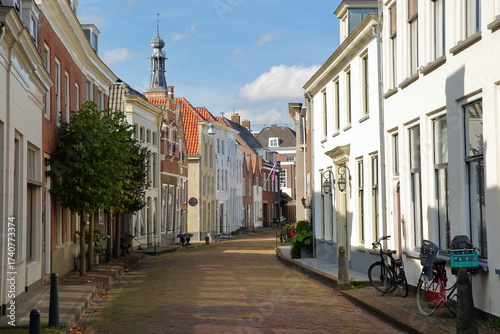 Traditional historic and colorful medieval houses located along Kerkstraat street in the old picturesque fortified town of Zaltbommel, Gelderland, Netherlands