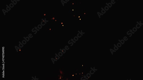 Slow motion of sparks and embers from campfire flying over black background
