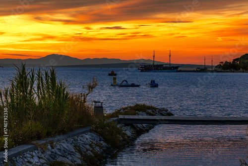 Fototapeta Naklejka Na Ścianę i Meble -  Sunset over the island and city of Rab in the Adriatic sea, Croatia
