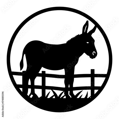 Silhouette of a donkey behind a wooden fence inside a circular frame