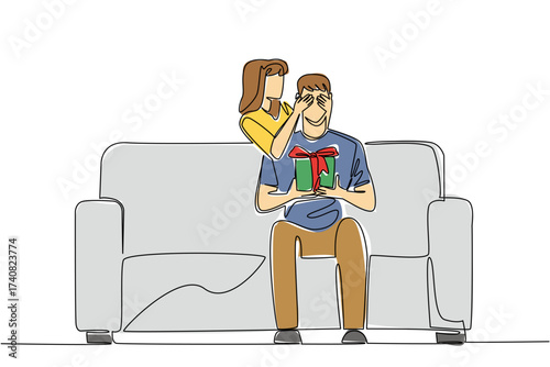 Continuous one line drawing a man sits on a sofa holding a gift box. The beloved wife gave a very interesting surprise. Romantic couple. Achieve. Surprise. Single line draw design vector illustration