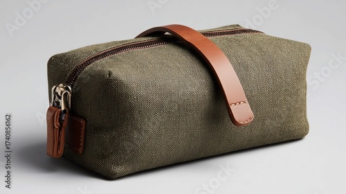 Sophisticated olive green canvas travel kit with stylish leather accents for the discerning traveler, perfect for organizing toiletries and essentials on your next adventure