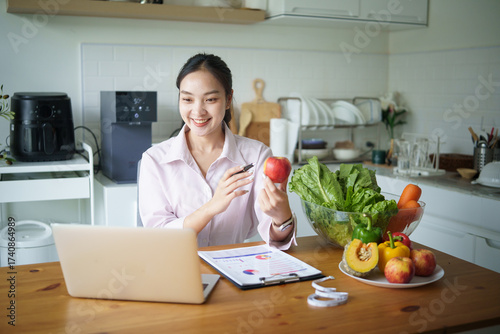 Asian dietitian providing virtual nutrition advice through video call. Concept of telehealth, and remote wellness.