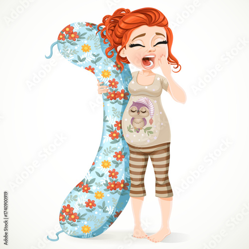 Beautiful sleepy pregnant brunette woman in pajamas with a long pillow for pregnant woman isolated on white background