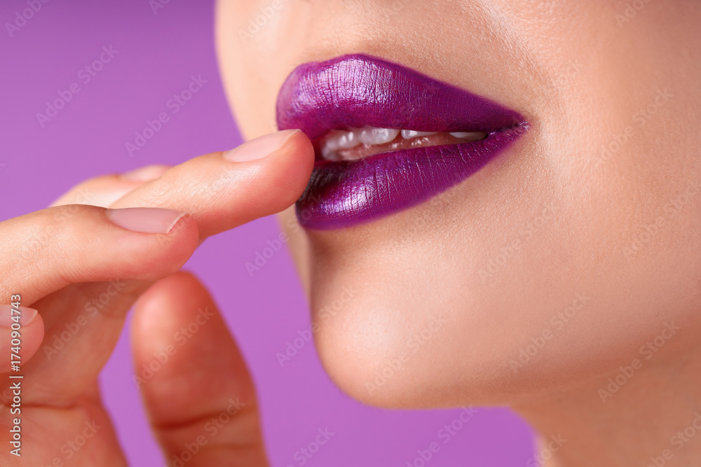 Naklejka premium Woman with bright lipstick on purple background, macro view