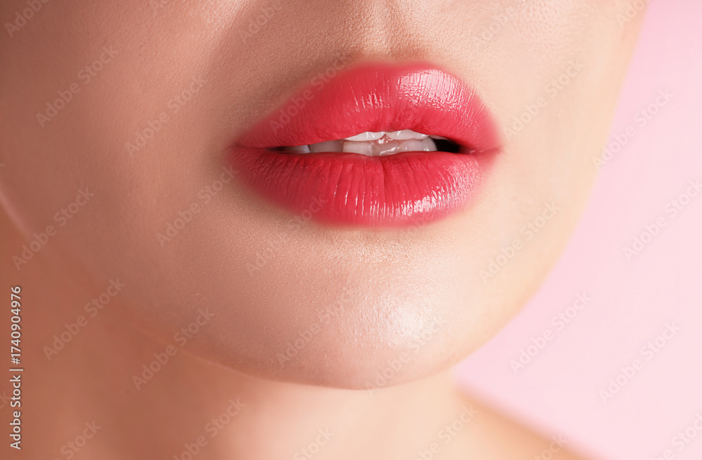 Fototapeta premium Woman with beautiful lipstick on her lips against pink background, macro view