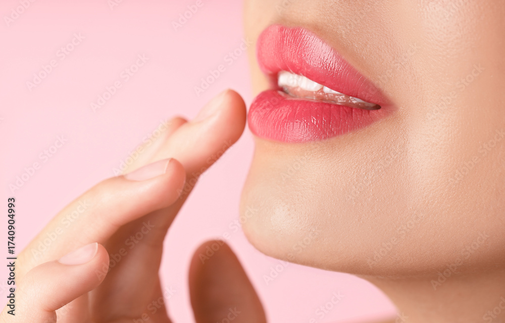 Obraz premium Woman with beautiful lipstick on her lips against pink background, macro view