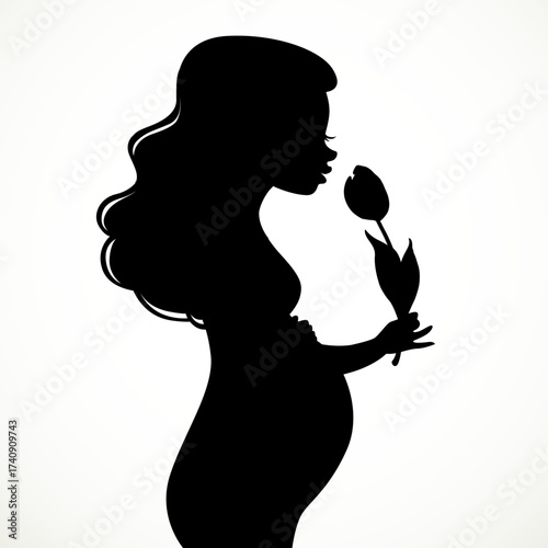 Silhouette of a beautiful young pregnant woman with lush hair sniffs a tulip flower isolated on white background