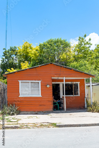 Pedernales, Dominican Republic, 8 august 2025. Typical Dominican Caribbean house made of wood, painted a bright red color.