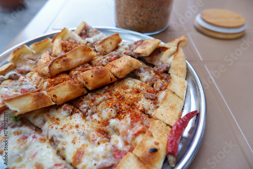 Meat and cheese pide from Tire, Izmir, Turkish cuisine, traditional dish known as ' kuşbaşılı kaşarlı pide'