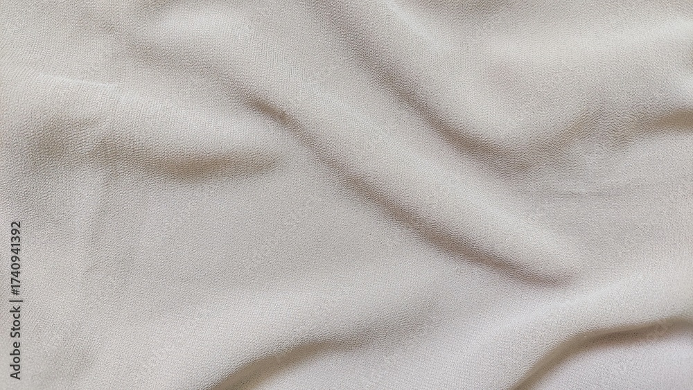 Fototapeta premium Wrinkled beige cloth background with soft cotton silk texture. Wavy fabric texture with smooth folds in cream color.