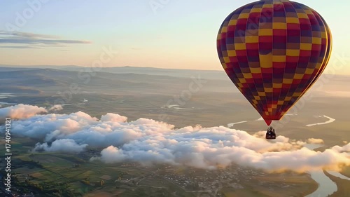 Colorful Hot Air Balloon Drifting Peacefully Above Clouds at Dawn.
