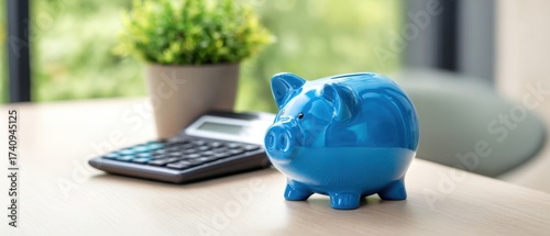 The blue piggy bank symbolizes savings and financial management in a modern workspace.