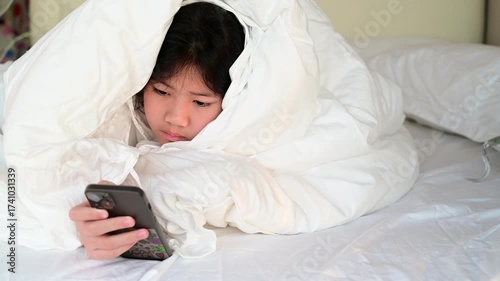 kid watching tablet on the bed, child addicted cartoon

