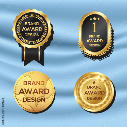 Collection of four golden brand award badges and medals on blue fabric background