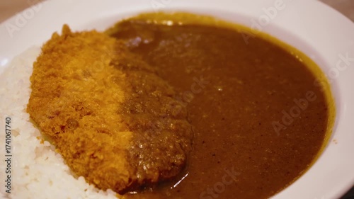 Tracking shot of hot Japanese curry rice with fried pork cutlet