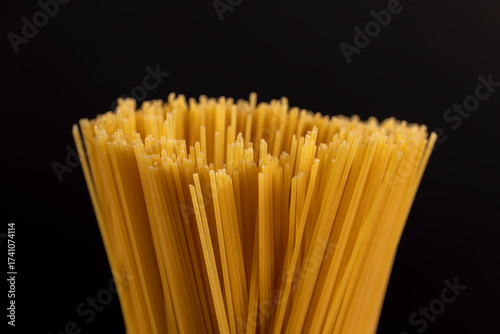 thin, long, hard yellow spaghetti made from durum flour using water , not cooked , hard spaghetti made from high-quality wheat flour, close up