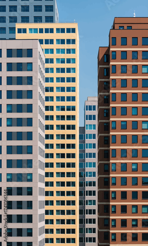Modern Urban Skyline: Tall Buildings in Yellow and Brown Under Clear Sky